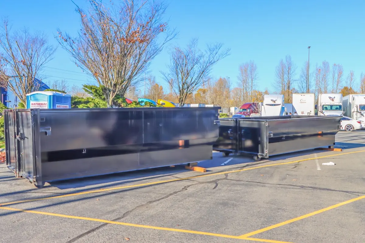 Professional dumpster rental service with roll-off container on residential driveway in Lakewood